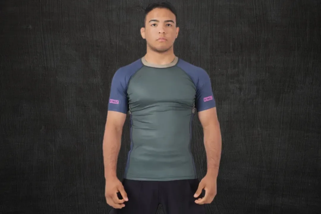 Athlete wearing a grey and blue no-gi rash guard
