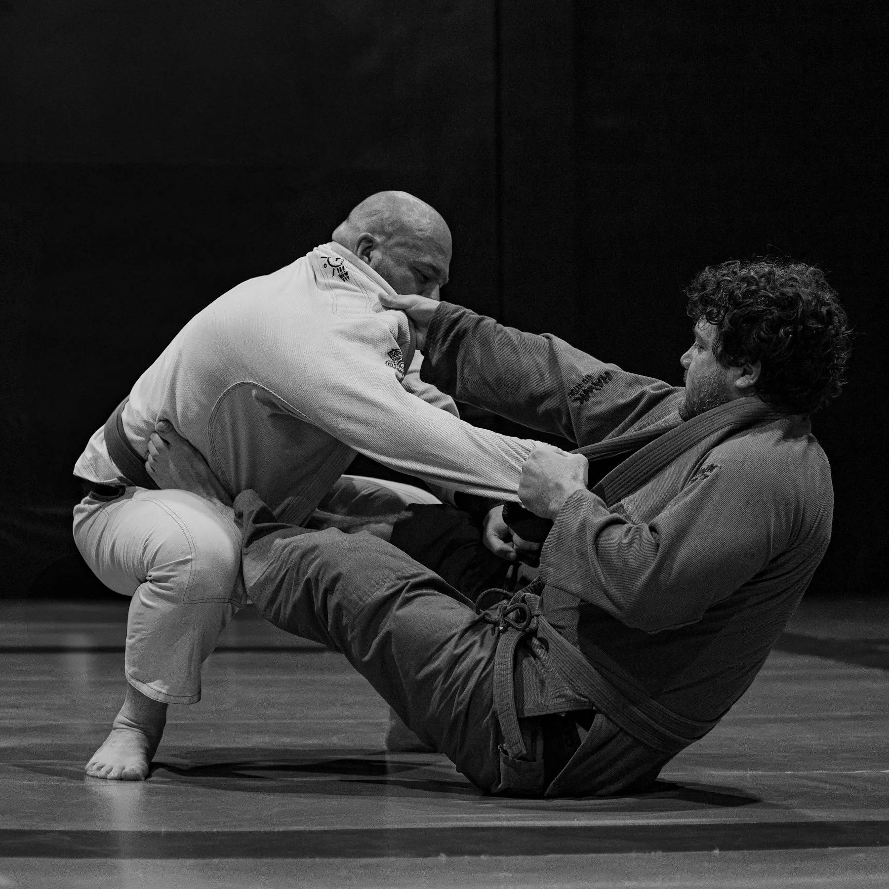 Two athletes grappling in No-Gi rash guards