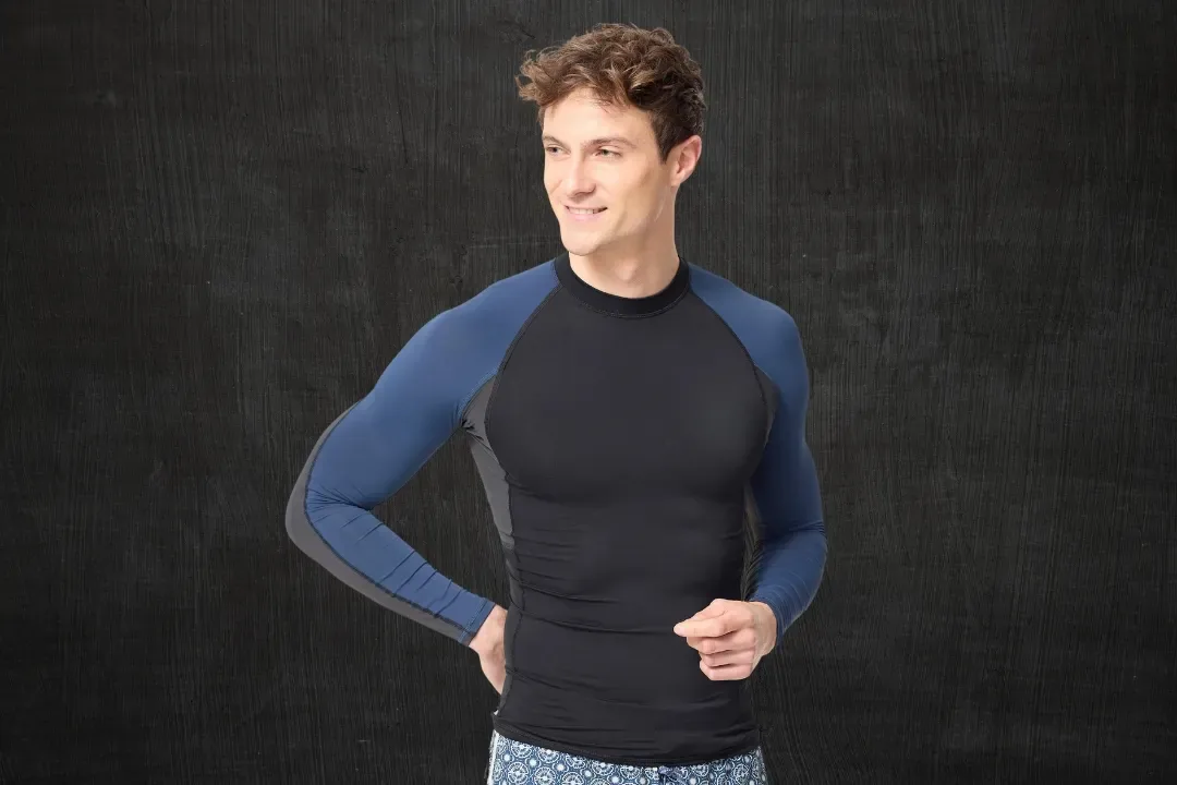 Man wearing a black and blue long sleeve rash guard
