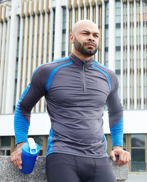 Man wearing a grey and blue private label rash guard