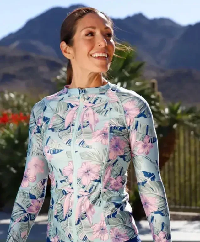 Smiling woman in a floral long sleeve rash guard