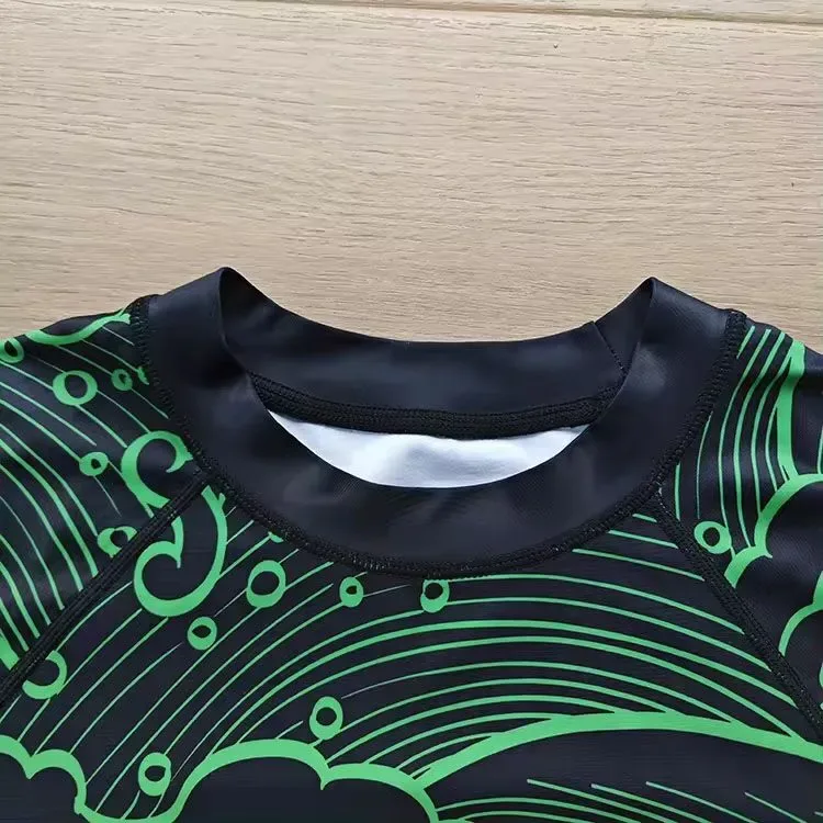 Collar detail of a black and green sublimated rash guard